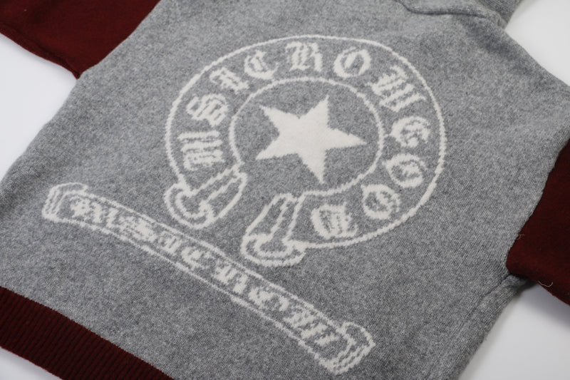 Close-up of large white star graphic on gray knit hoodie back
