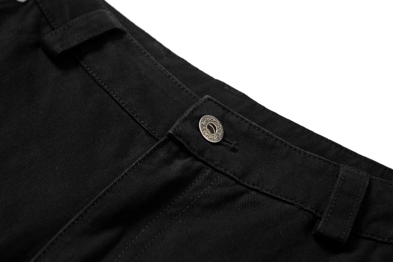 Close-up of black cargo pants waistband snap button and top seam detail