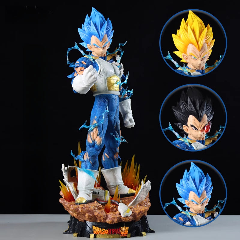 The Seakoff Vegeta Collectible Figure from Dragon Ball Z features an animated Vegeta with spiky blue hair and a blue and white outfit on a rocky base with flames. It includes three interchangeable heads: Super Saiyan (yellow), Normal (black), and Super Saiyan Blue (blue). Size: 55cm.