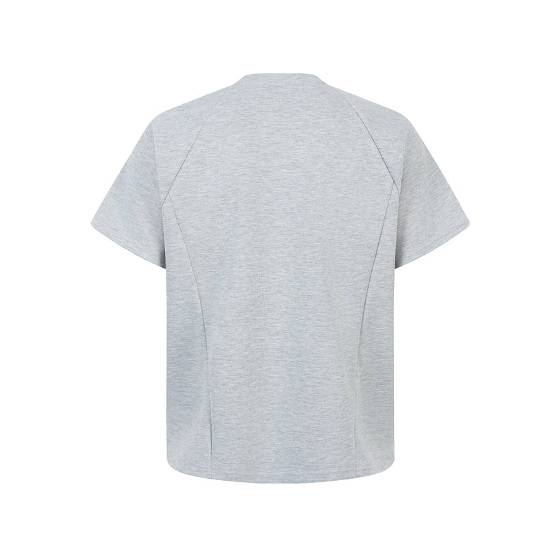 Light gray oversized tee with geometric seam panels and a minimal structured cut, shown flat on white background