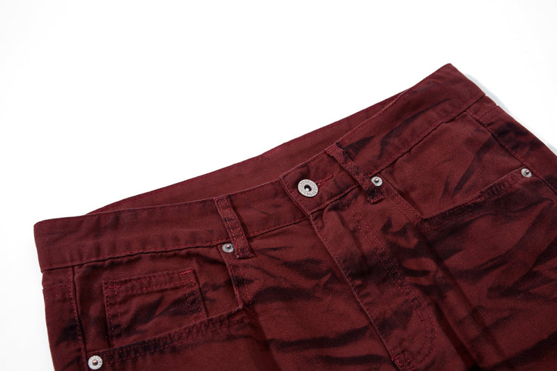 Close-up of the waistband and front pockets on burgundy tiger-print pants