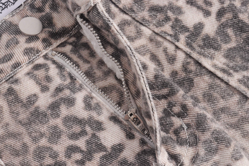 Close-up of front zipper fly and button on leopard print jeans