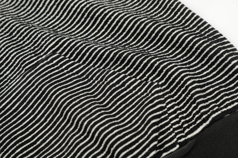Close-up of black-and-white striped fabric on the hoodie