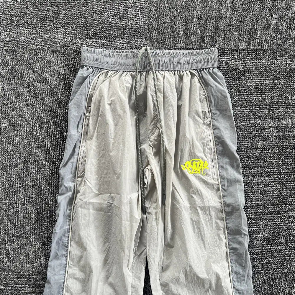 Syna World Grey Yellow Logo Track Pants