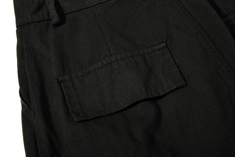 Close-up of black cargo pocket flap on the side of the pants