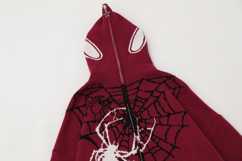 Angled view of burgundy hooded zip hoodie with white hood accents and spiderweb knit body