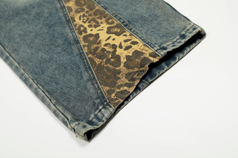 Close-up of hemmed blue denim leg with leopard-print side panel