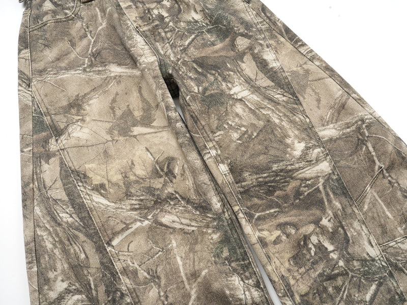 Side view of forest camo wide-leg pants showing loose leg shape and seam lines