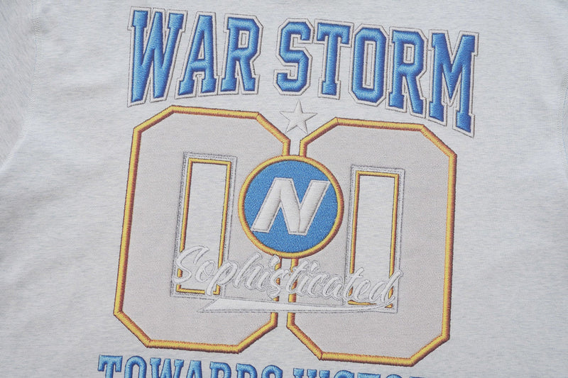 White varsity graphic tee with blue War Storm lettering and a large embroidered number 00 design on the front