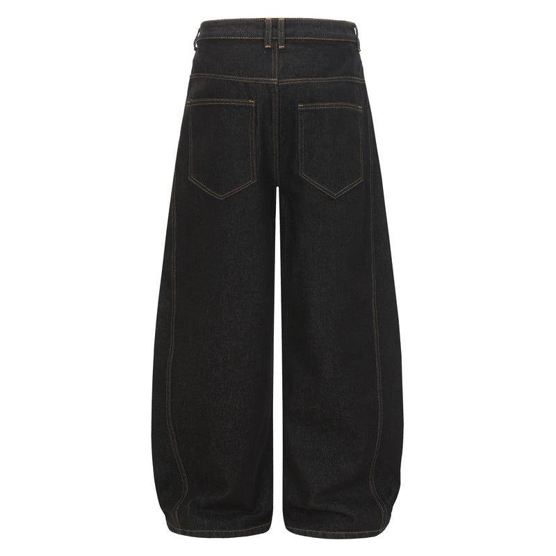 Back view of black wide-leg denim pants with patch pockets and contrast orange stitching