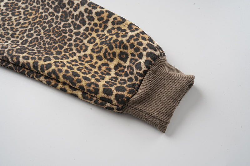 Leopard print hoodie sleeve ending in brown ribbed cuff
