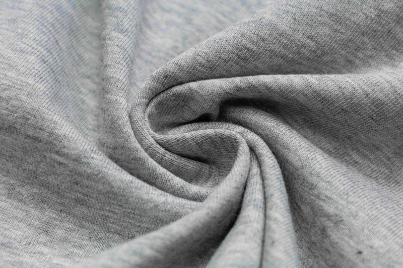 Close-up of soft gray heathered fabric with a spiral fold, showing the texture of a vintage ringer T-shirt