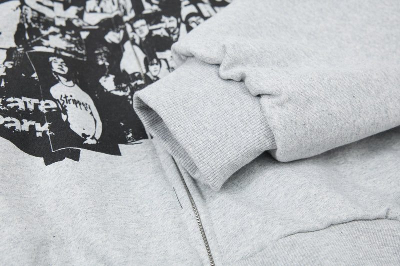 Close-up of light gray hoodie sleeve cuff and printed front panel