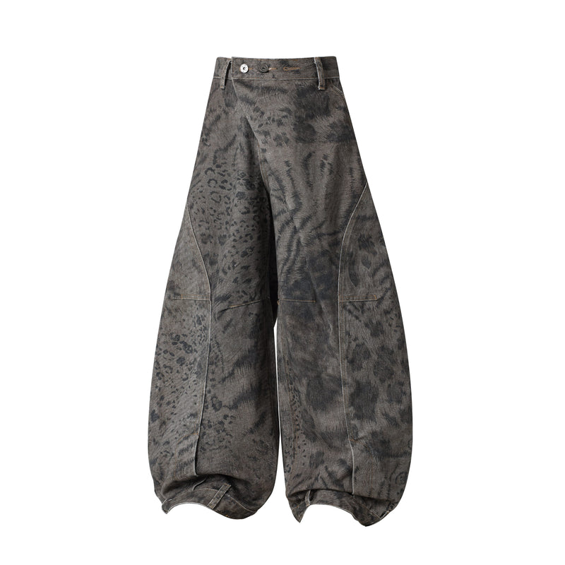 Front view of dark washed wide leg balloon jeans with mottled pattern and button waist