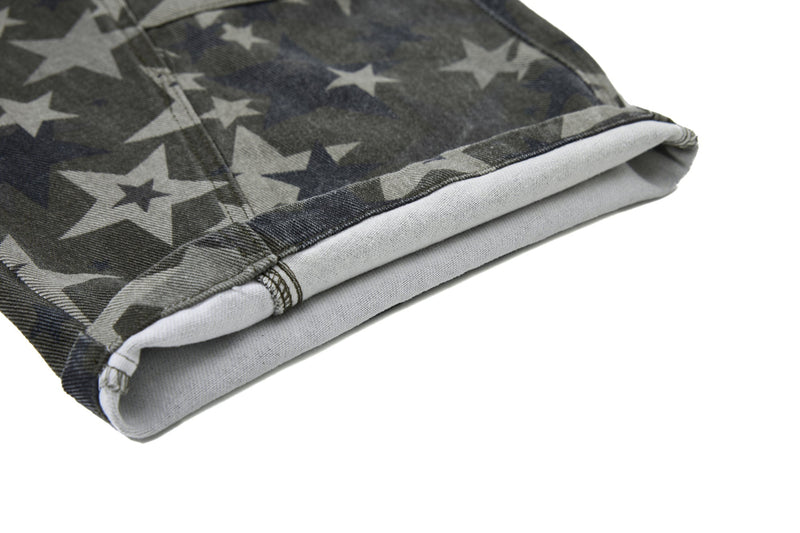 Close-up of cuffed hem showing light inner denim on star print jeans