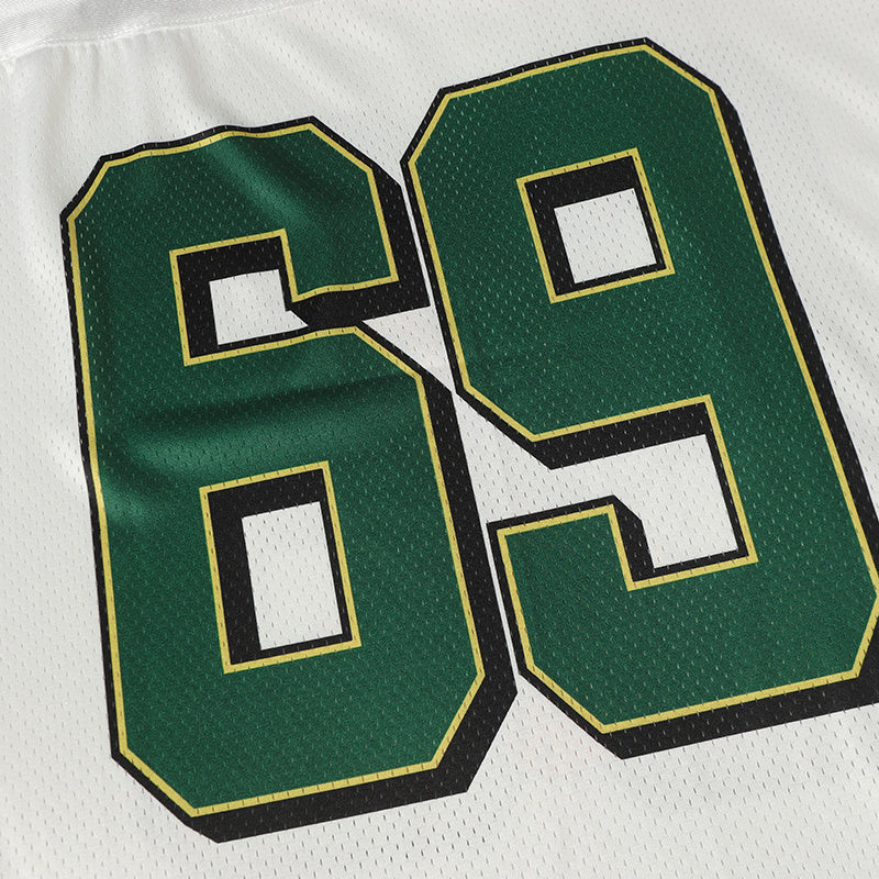 Close-up of green varsity jersey number 69 with black and gold trim on white mesh fabric