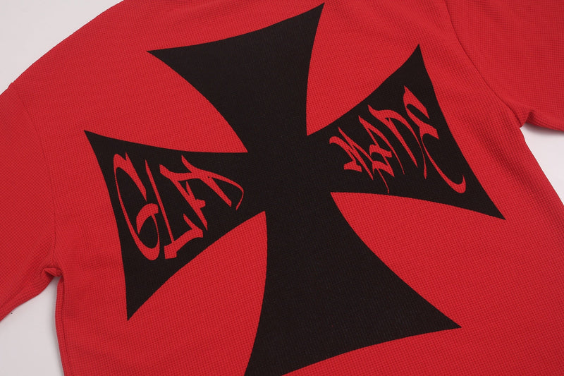 Red oversized graphic tee with bold black cross and graffiti-style print on the back
