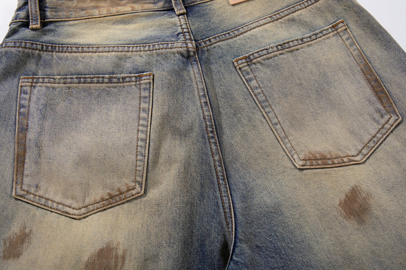 Back pocket close-up on faded gradient denim with contrast stitching