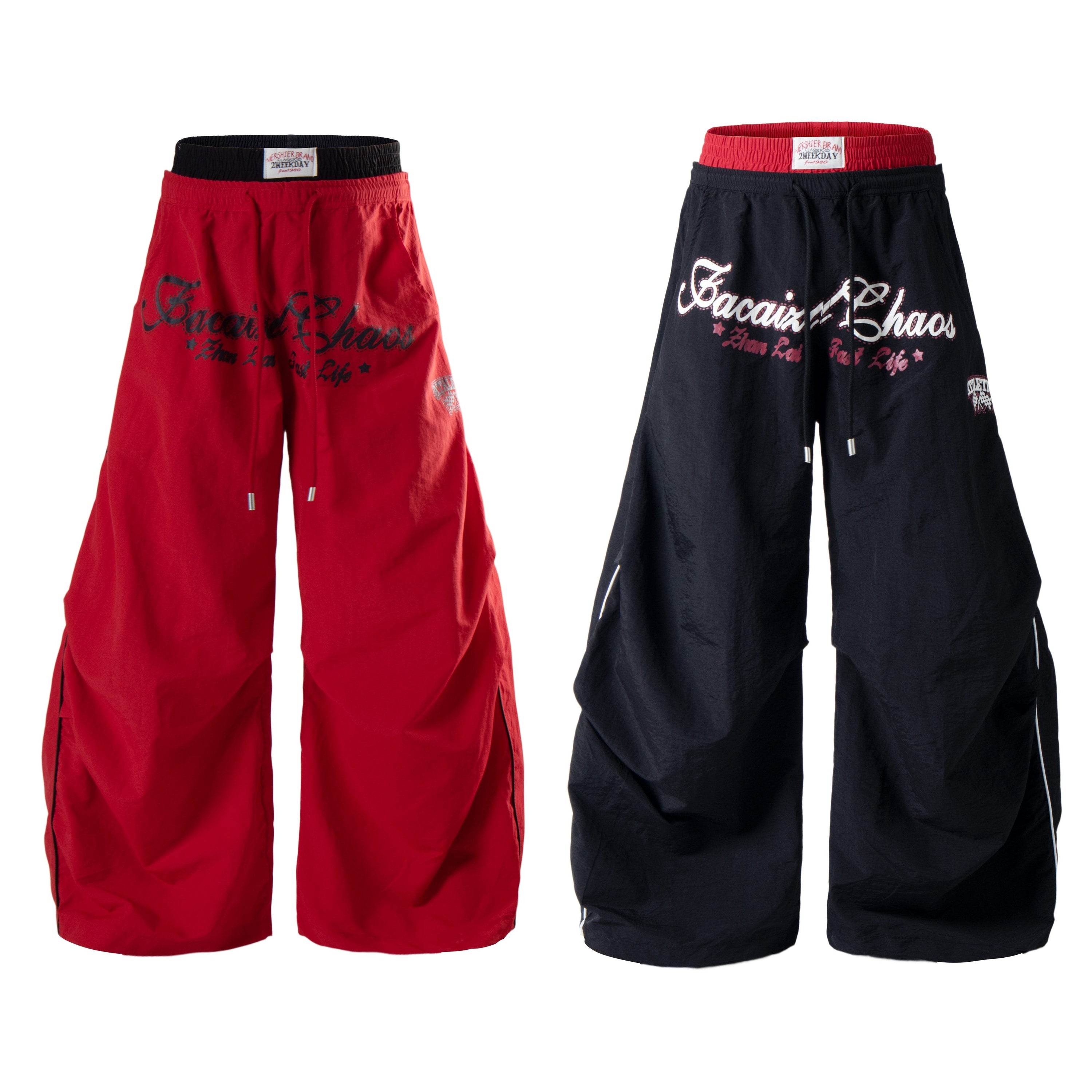Red and black oversized balloon wide-leg streetwear pants with vintage cursive graphic print and contrast double-layer waistb