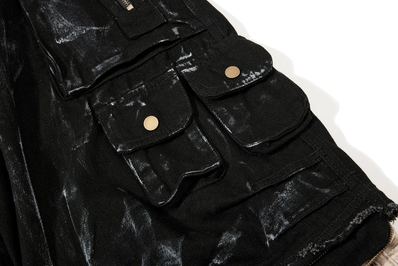 Side cargo pockets with flap closures and gold-tone snaps on black washed denim