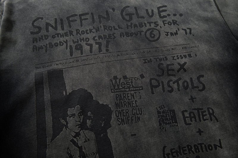 Washed black graphic T-shirt with Sniffin’ Glue punk zine print and bold 1977-style distressed lettering