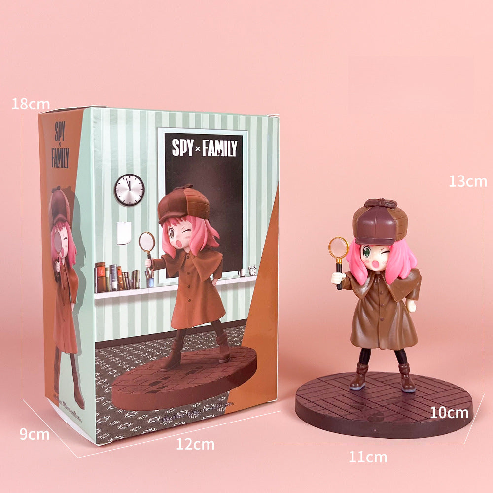 The Spy x Family Detective Anya PVC Figure Set, 14 cm Movie Version, features Anya with pink hair in a detective outfit and holding a magnifying glass. It includes four poses on round bases, and comes with a box displaying the character.