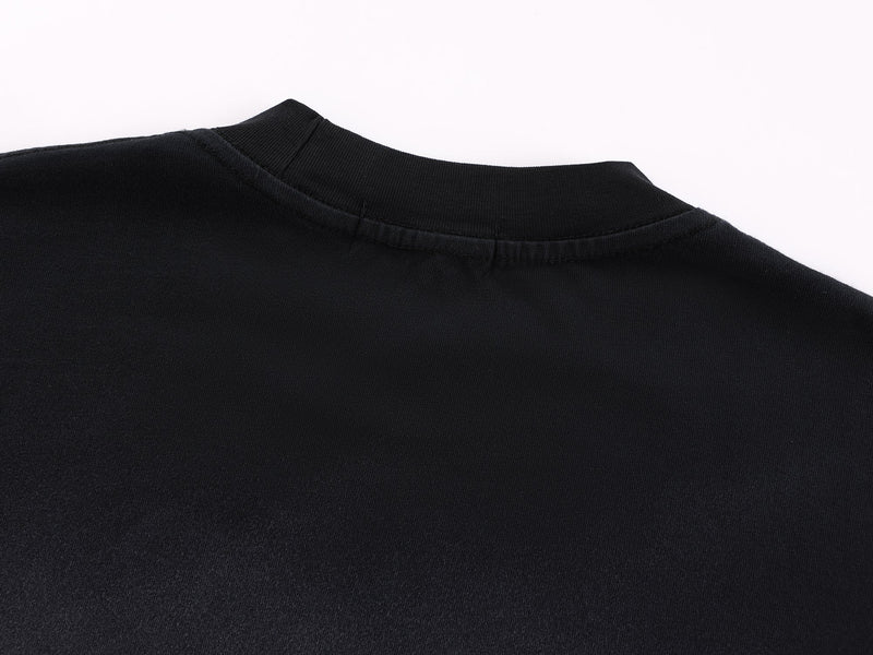 Close-up of black crew neck collar with ribbed trim and top stitching
