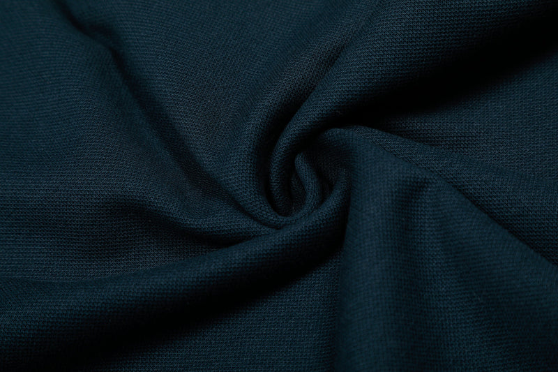 Close-up of navy fabric drape with soft folds and knit texture