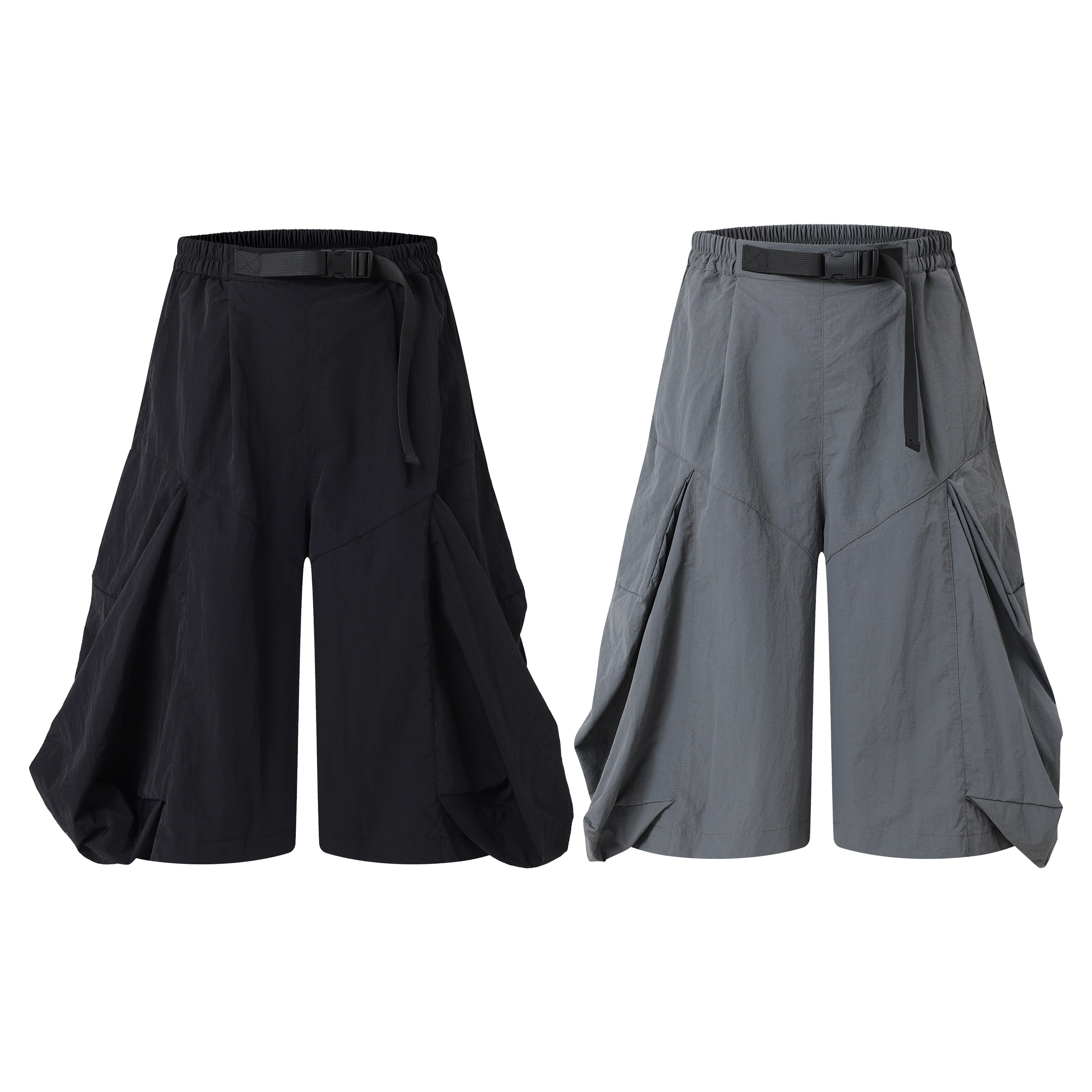 Omirad draped wide-leg shorts in black and grey, featuring exaggerated side panels and adjustable webbing belt waistband