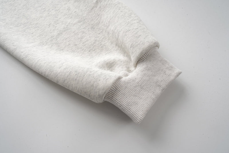 Cuffed sleeve on light gray hoodie with ribbed wrist detail