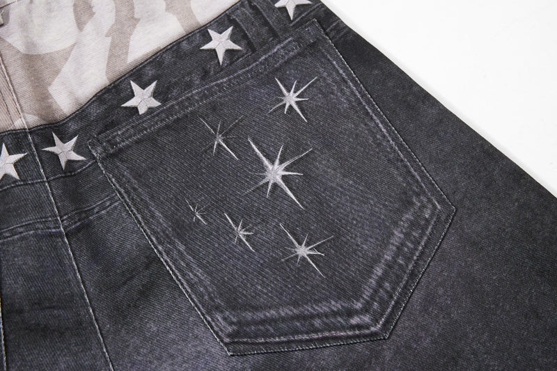 Close-up of back pocket on black denim with star print and sparkle graphic