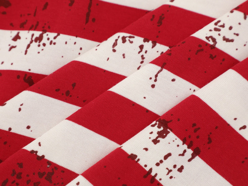 Close-up of cream tee striped fabric with red and white bands and distressed print