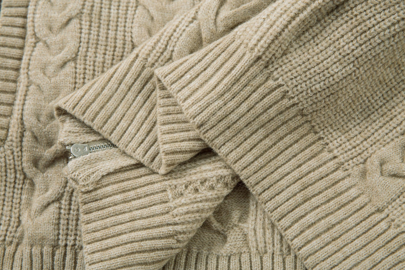 Beige cable knit sweater jacket sleeve and front hem with zipper edge close-up