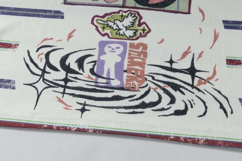Close-up of black swirl graphic and small printed details on white shirt hem
