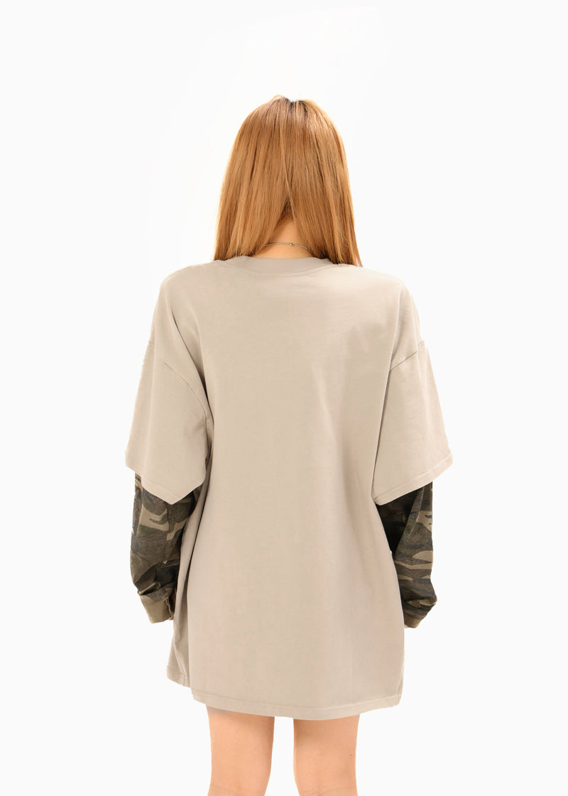 Back view of beige oversized T-shirt with camouflage sleeves and relaxed fit