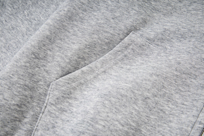 Close-up of light gray fleece hoodie fabric and seam detail