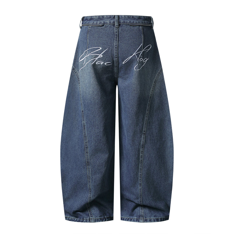 Blue wide-leg jeans with white script and back zip pockets, back view