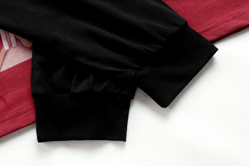 Sleeve and hem detail of black and red raglan long sleeve tee