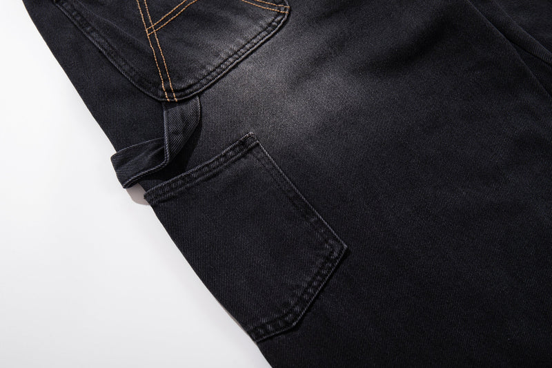 Close-up of side cargo pocket on black wide-leg denim carpenter jeans