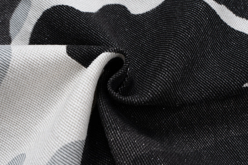 Close-up of camo denim fabric texture with black and white print