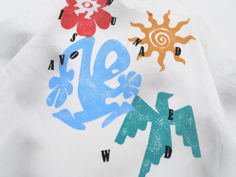 White graphic tee with colorful abstract sun and flower prints in red, blue, orange, and teal streetwear style