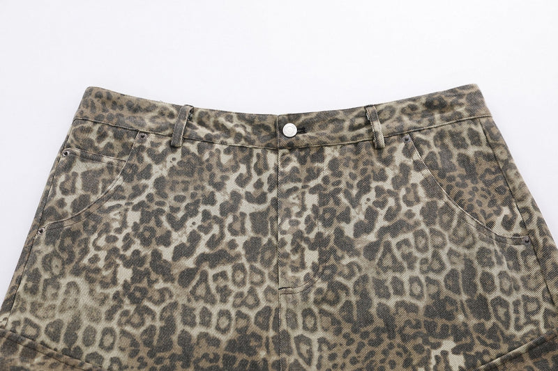Close-up of front waist on leopard print cargo shorts with button closure and belt loops