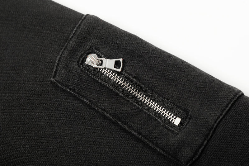 Close-up of zipper pocket on black hoodie sleeve