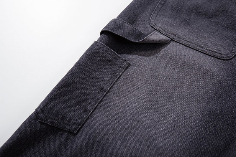 Close-up of side cargo pocket on dark denim wide-leg shorts