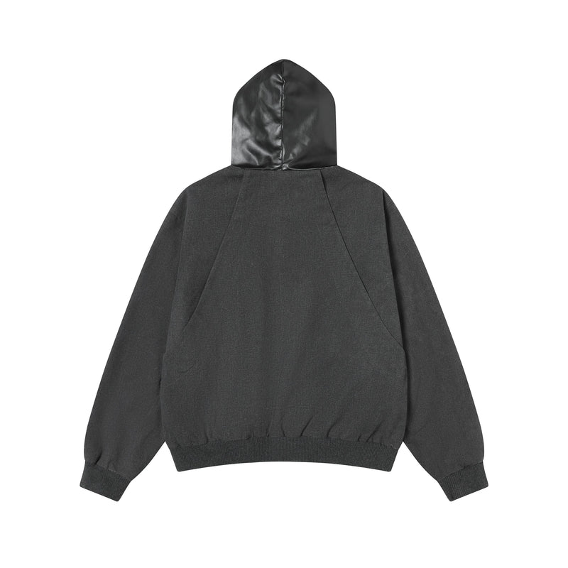 Back view of black hooded jacket with smooth faux leather hood and ribbed hem