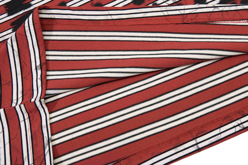 Close-up of red and white striped cotton T-shirt fabric with black accents and visible seam stitching
