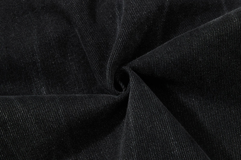 Close-up of black denim fabric folds and texture