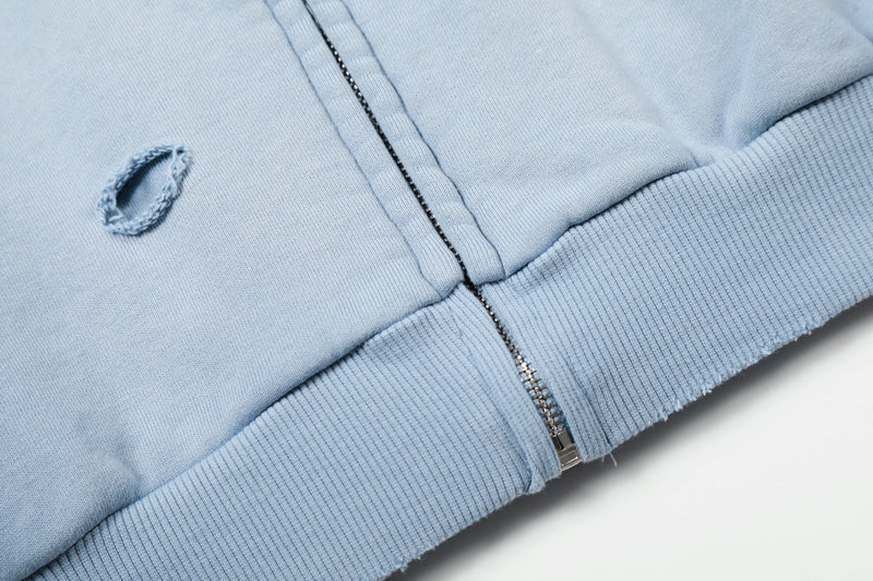 Close-up of light blue hoodie hem and zipper seam