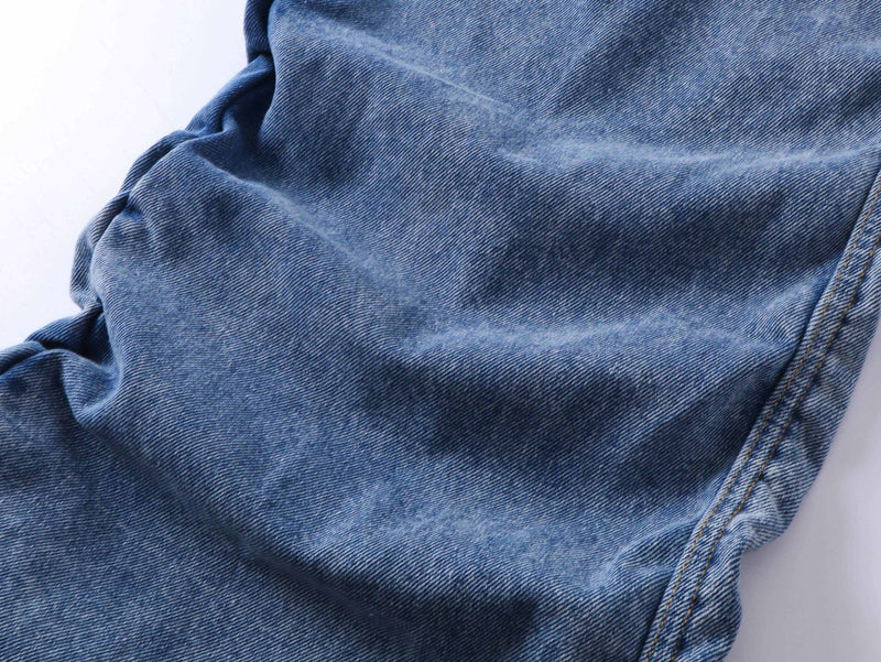 Close-up of blue jeans leg with stacked wrinkle detail