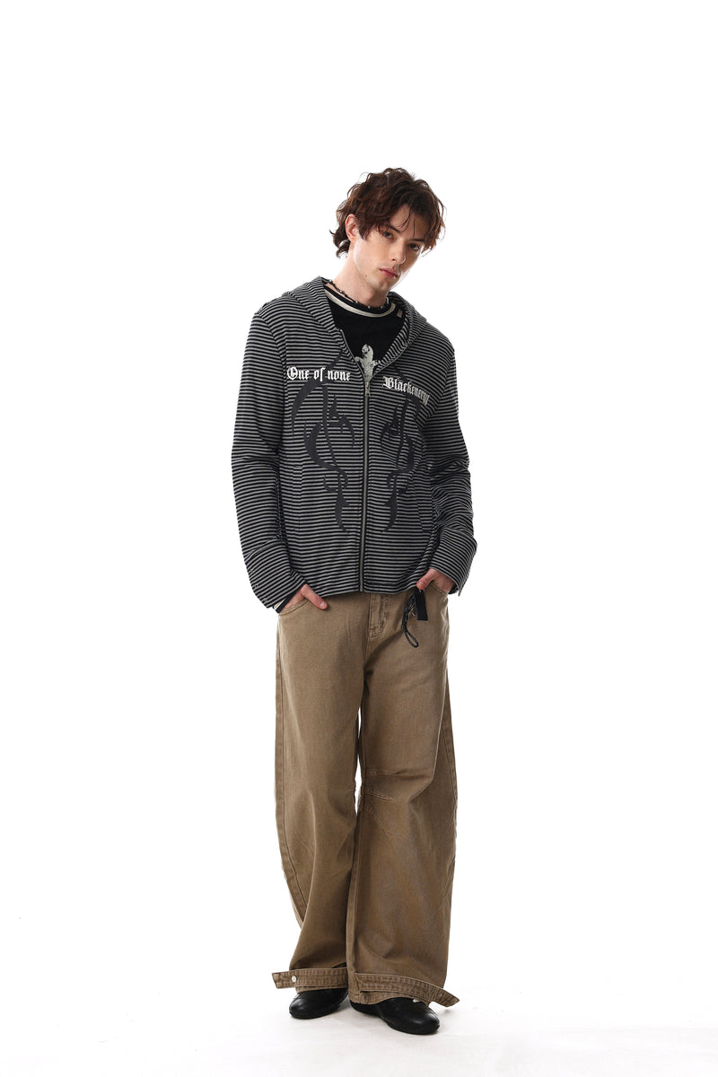 Full-body model view of black striped zip hoodie with front graphic and hood up